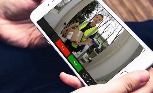 Holding Smartphone With Doorbell Cam App